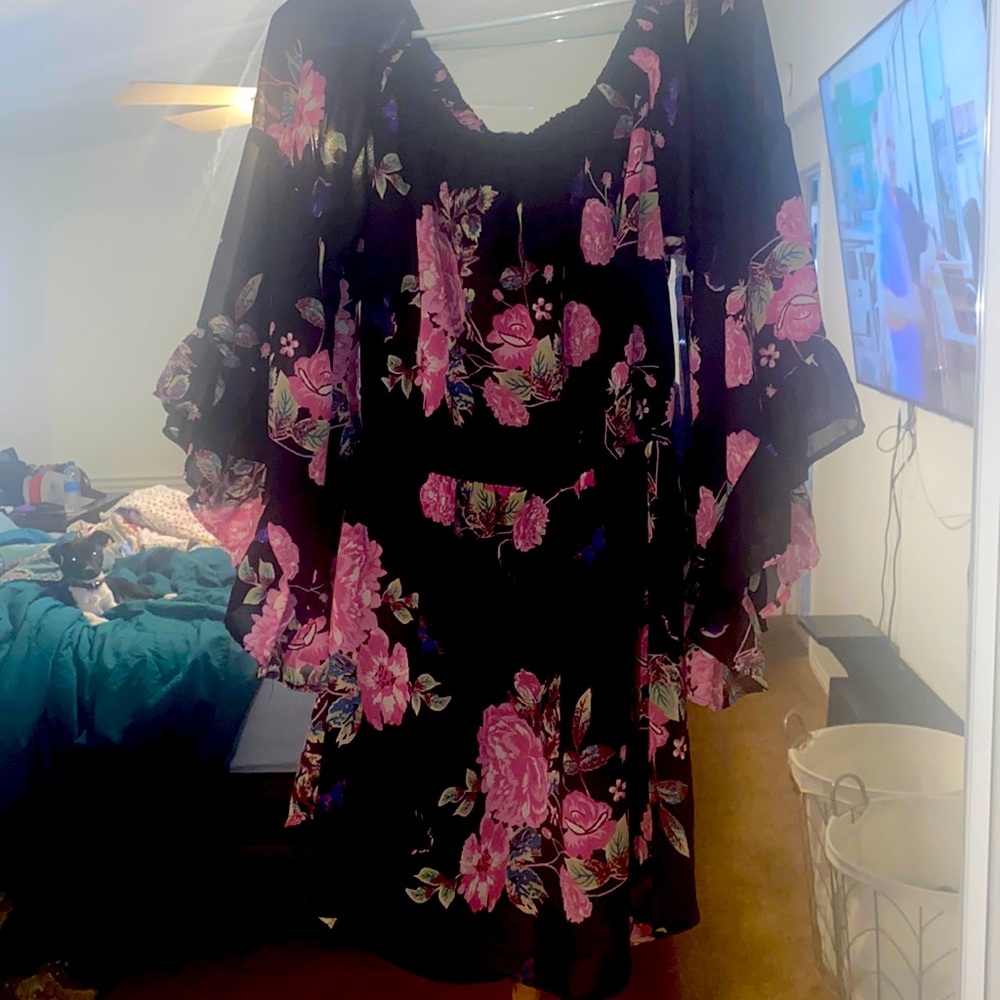 Never worn, flowery and  flows with your body shape.
